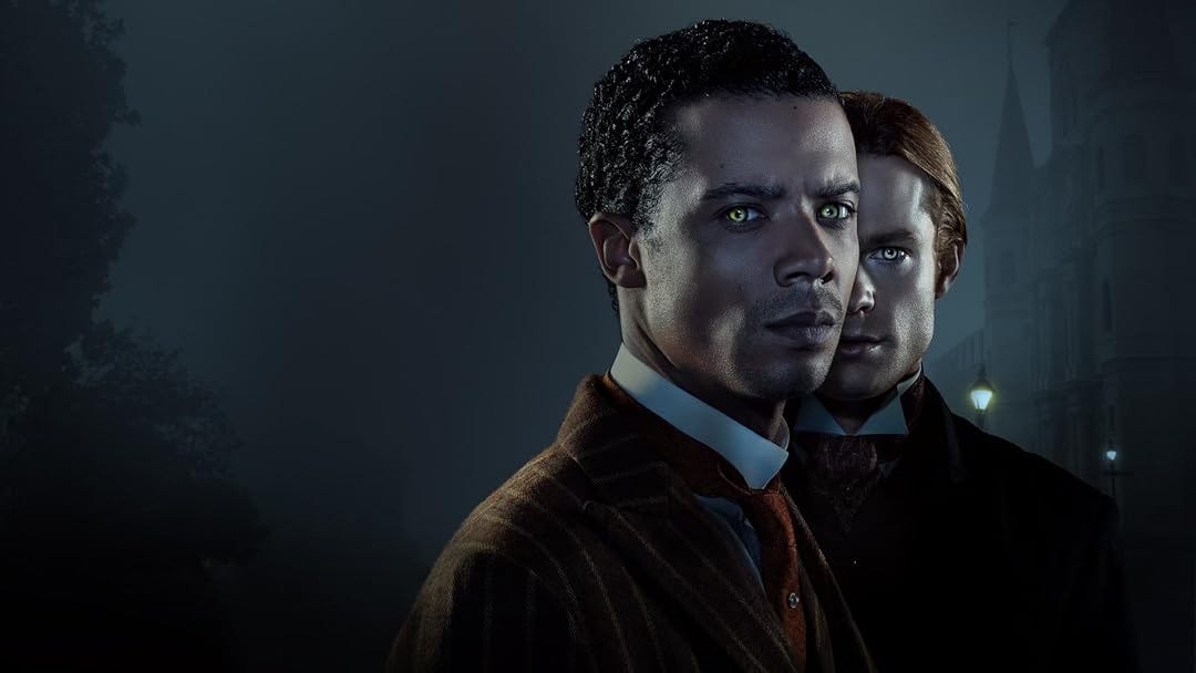 official poster image for interview with the vampire featuring sam reid and jacob anderson standing in the dark, their eyes aglow