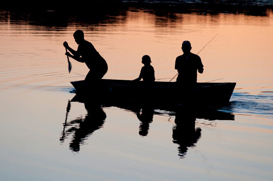 People fishing in lake
