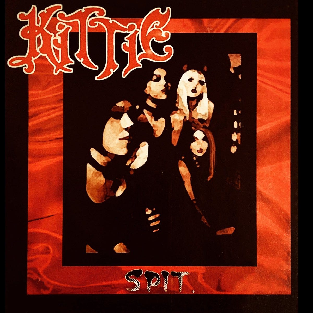 The cover for Kittie’s SPIT. It shows a painting of the band gathered in a group, kind of looks like one of those deals where they paint over the photo, mostly done in tones of black and tan. The picture has a red border, which i think is a photo of red satin sheets.