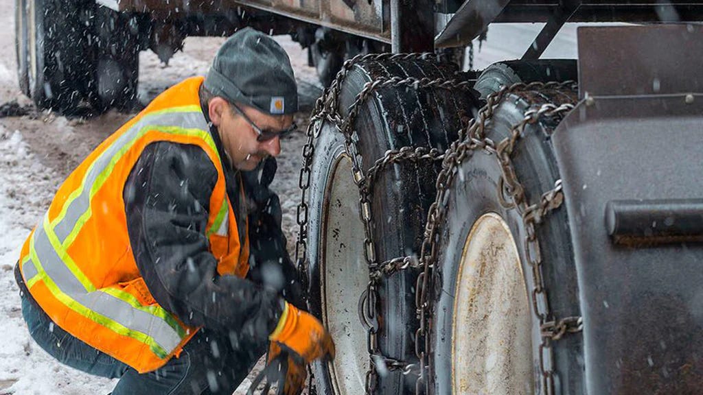 Truck driver with tire chains