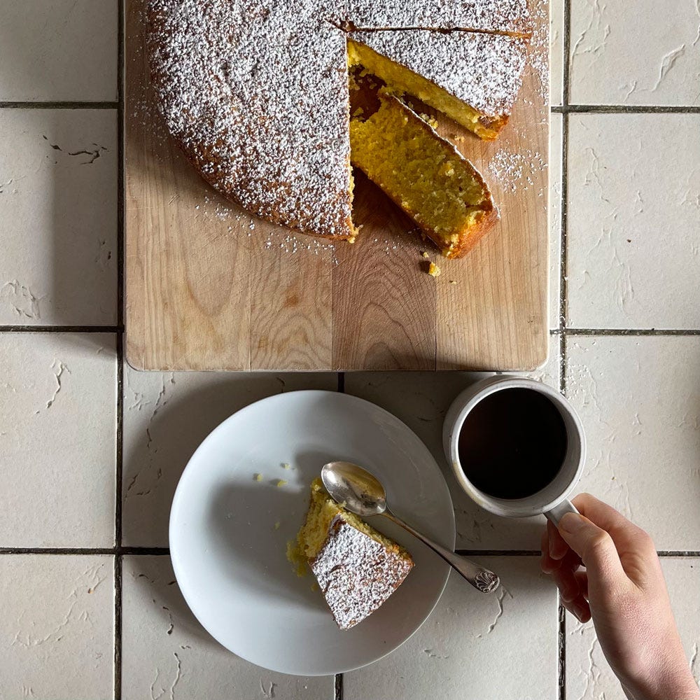 Orange cake sliced with cup of coffee