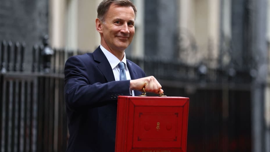 Britain's Chancellor of the Exchequer Jeremy Hunt holds the budget box as he poses for pictures at Downing Street in London, Britain March 15, 2023. REUTERS/Hannah McKay