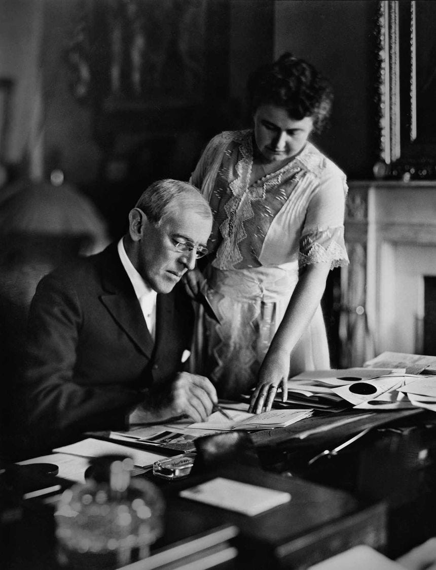 President Woodrow Wilson and his wife Edith review papers in the Oval Office