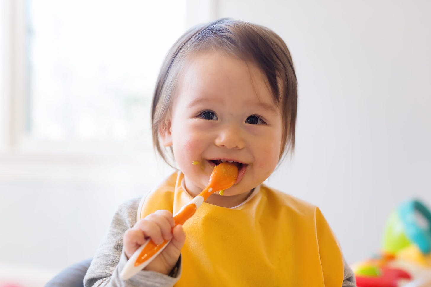 Image of a happy little baby boy with preferences for healthy foods