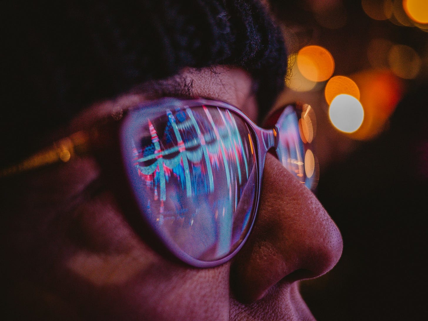 A close-up photo of a person wearing sunglasses