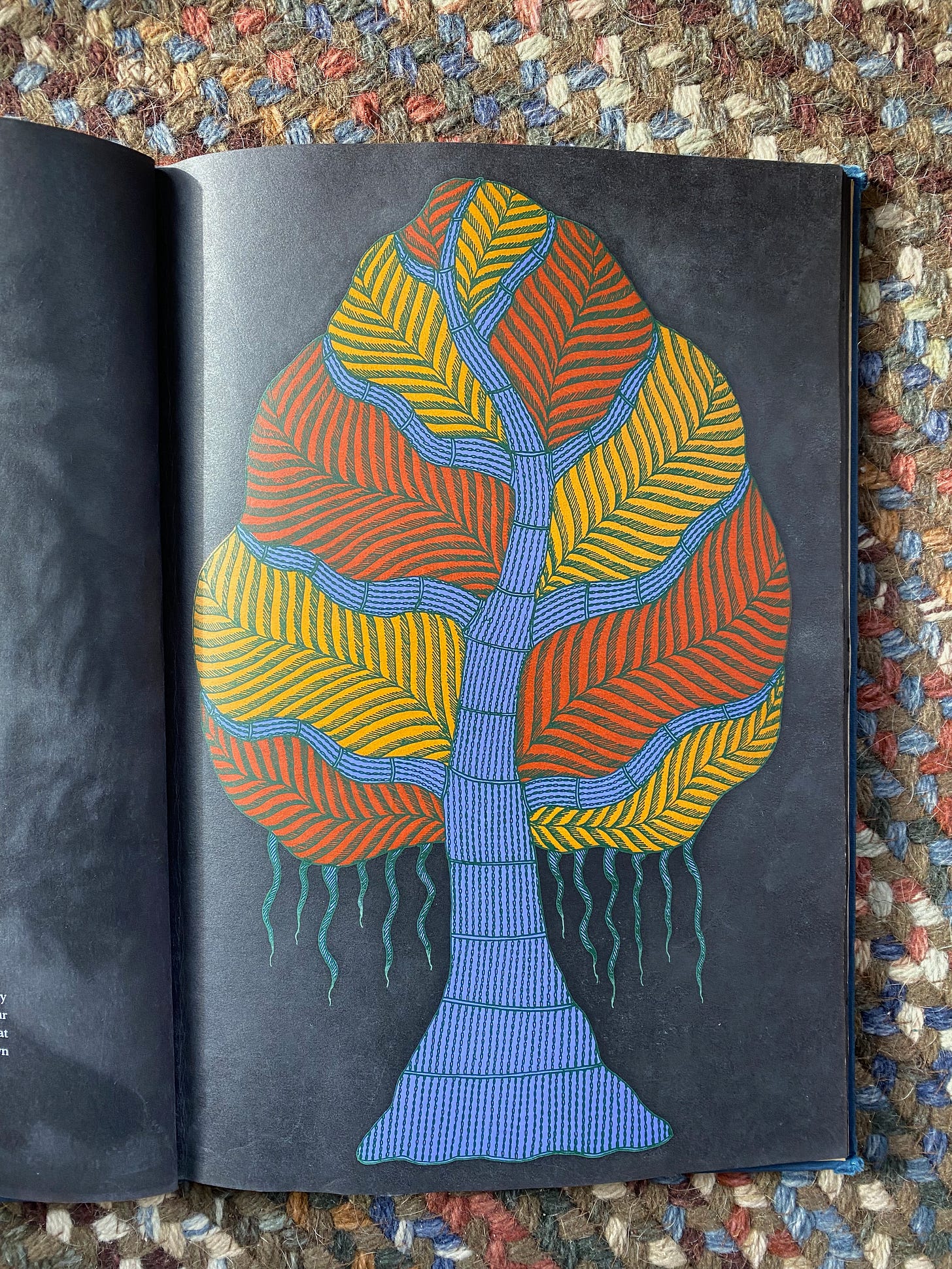 Image from the book: A stylized tree that looks like a large leaf, with blue branches and red and yellow leaves. 