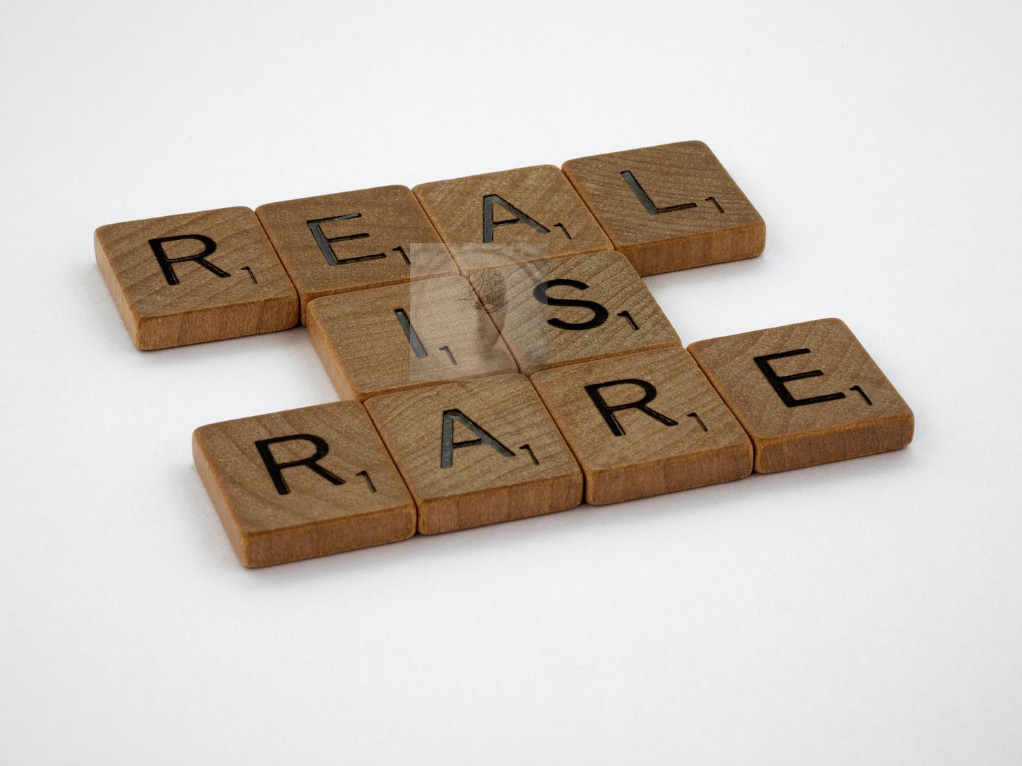 Real is Rare scrabble tile words; Photo by Brett Jordan on Unsplash