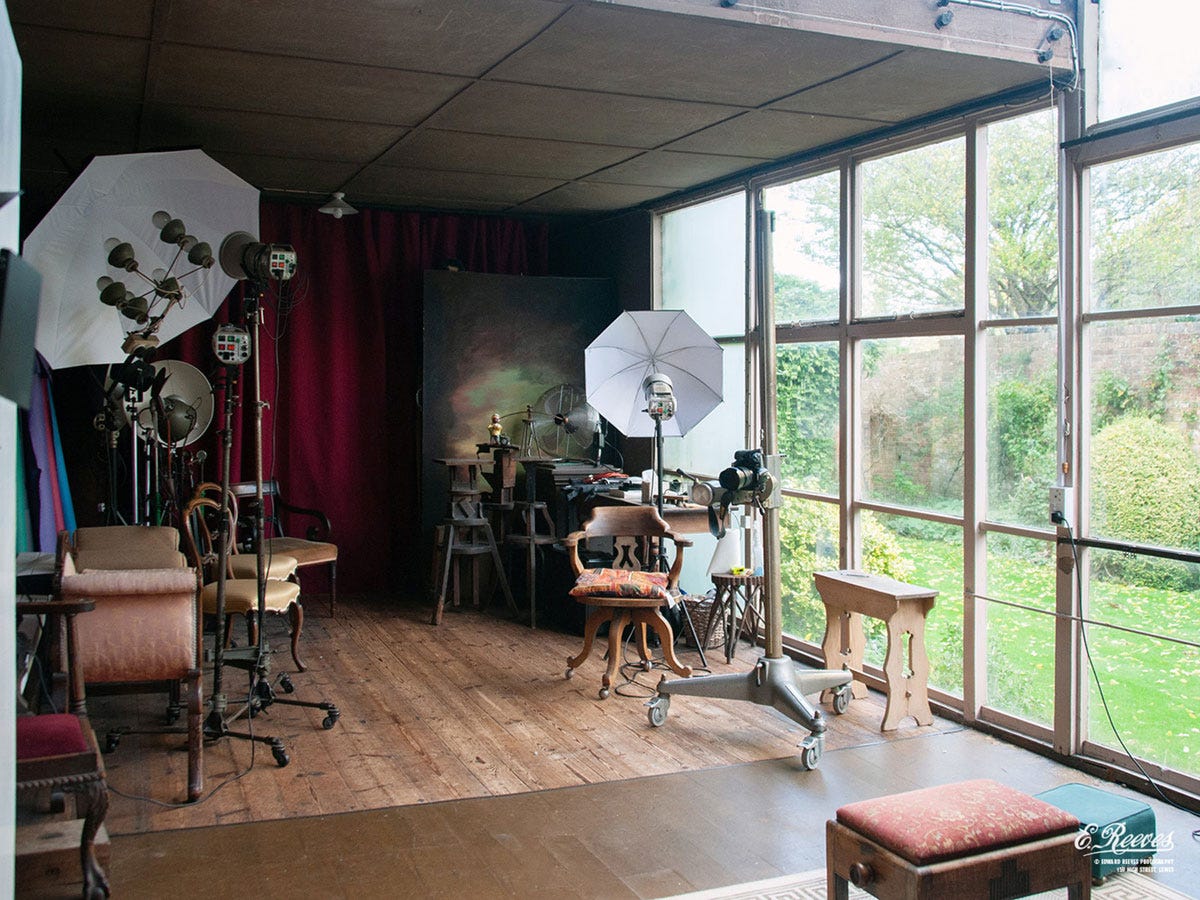 a photography studio with a large window on one side