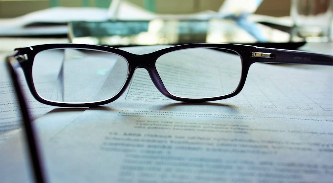 black-framed eyeglasses on white printing paper black-framed eyeglasses on white printing paper