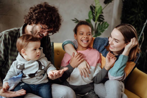 Happy family sitting on the couch Happy Family sitting on the couch foster stock pictures, royalty-free photos & images