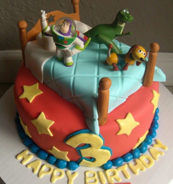 This may contain: a birthday cake with toy story characters on it