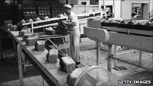 25th November 1965: A line of baked loaves ready to be packed at the Wonderloaf Bakery, Tottenham, north London.