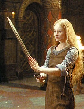 Miranda Otto, as Éowyn, holding a sword, in The Golden Hall.