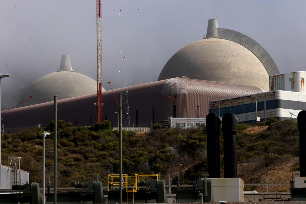 Two domes rise into the sky at a nuclear power plant.