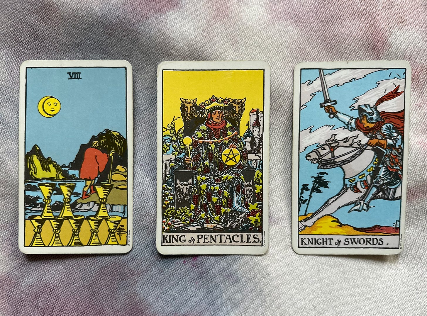Photo of the Eight of Cups, King of Pentacles, and Knight of Swords