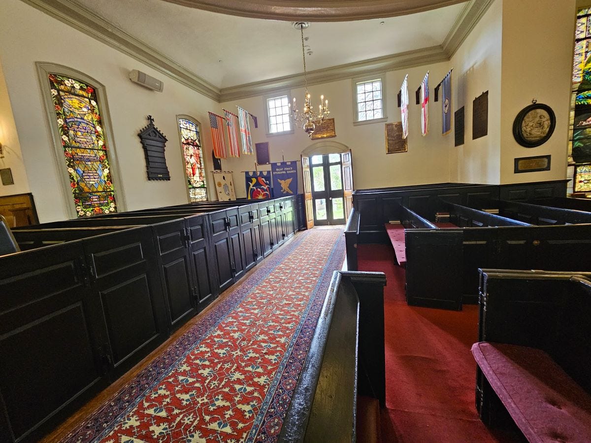 historic saint johns church inside with dark wood pews