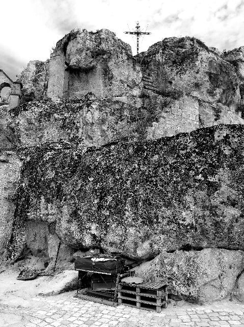 walking around the Sassi in Matera: the cross on top of the rock indicates this is a church