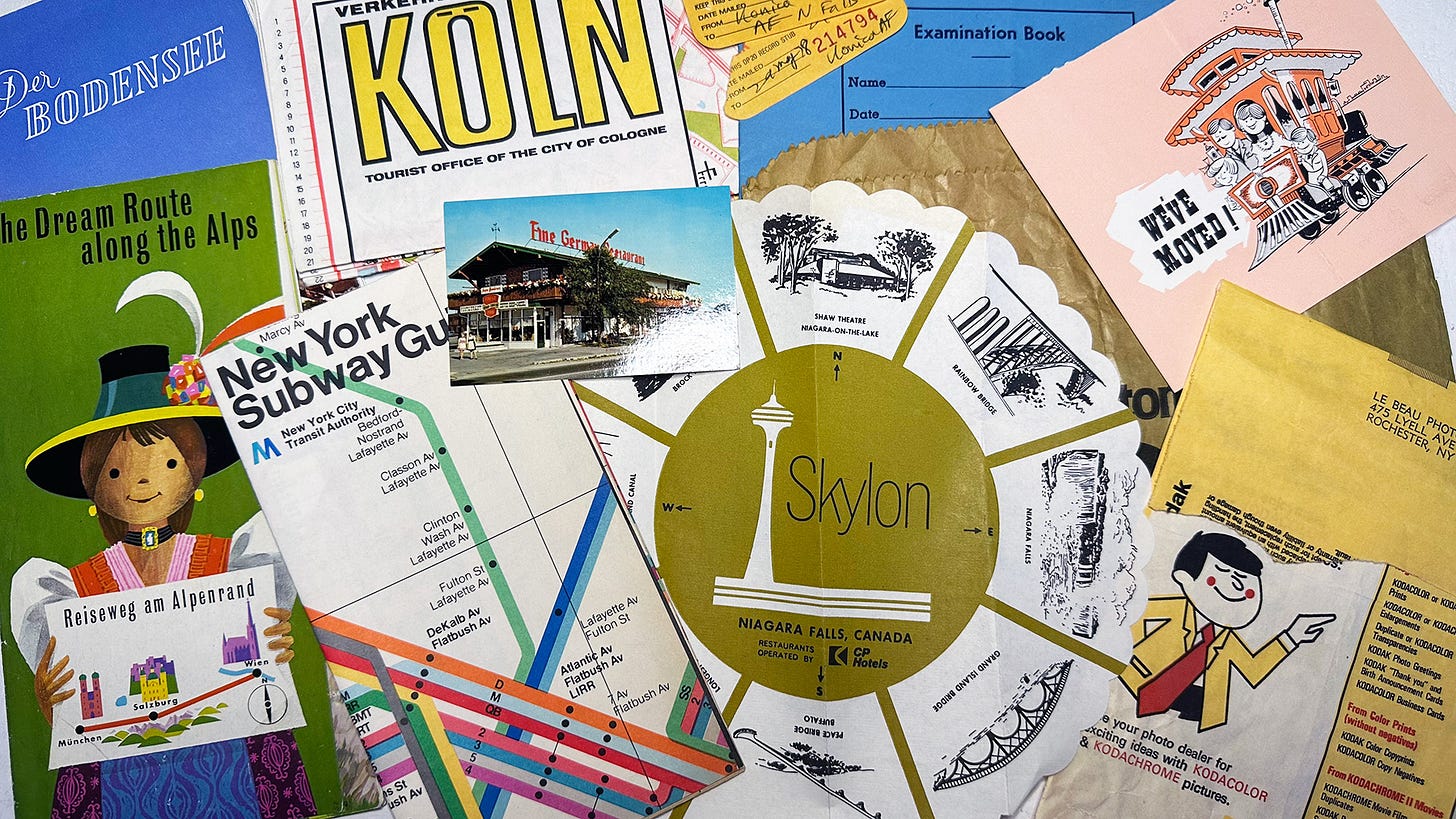 A pile of paper ephemera including maps and other travel nostalgia, and an envelope from Kodak film