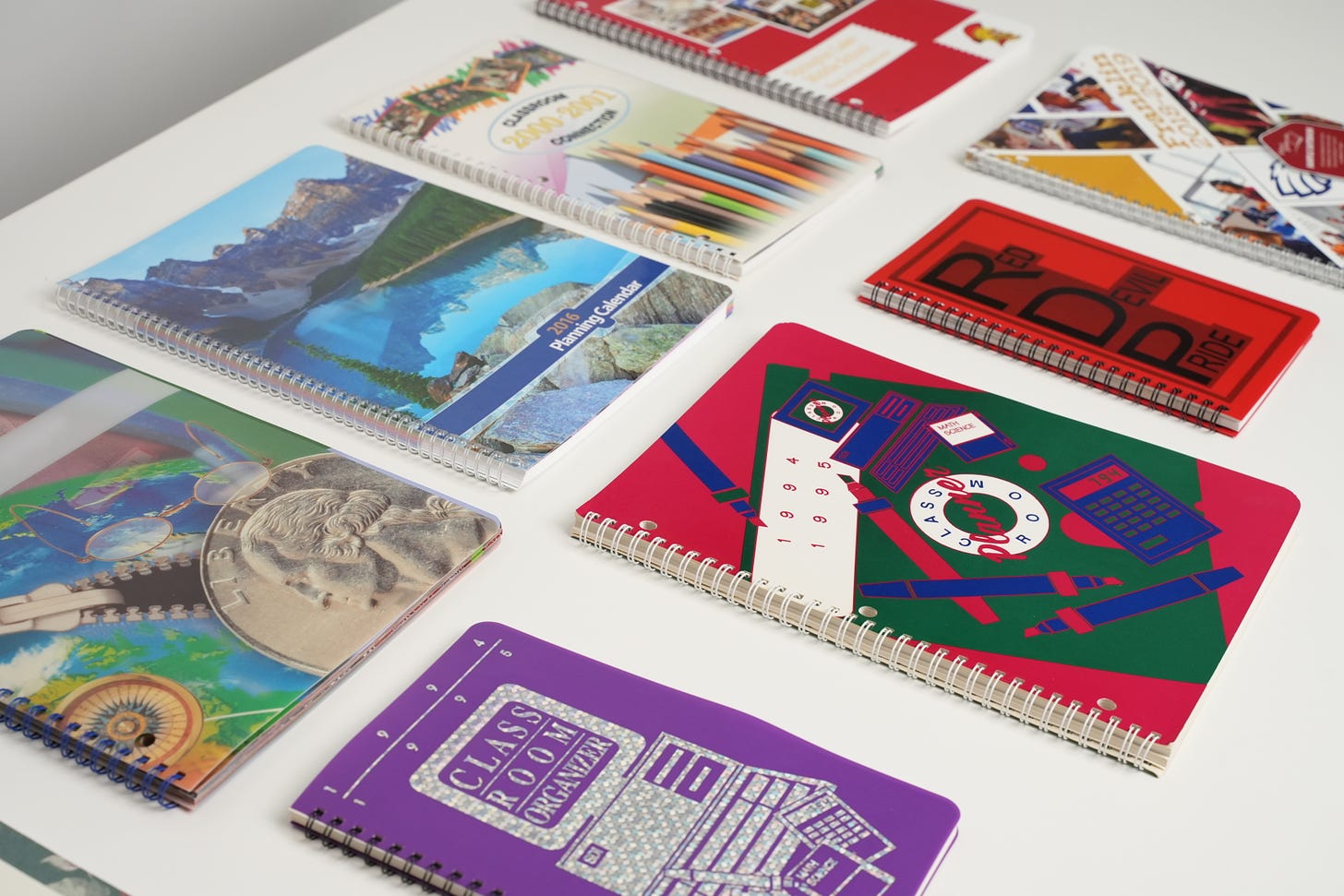 image of several planners, including those from 1994-1995, 2016, 2000-2001, and more