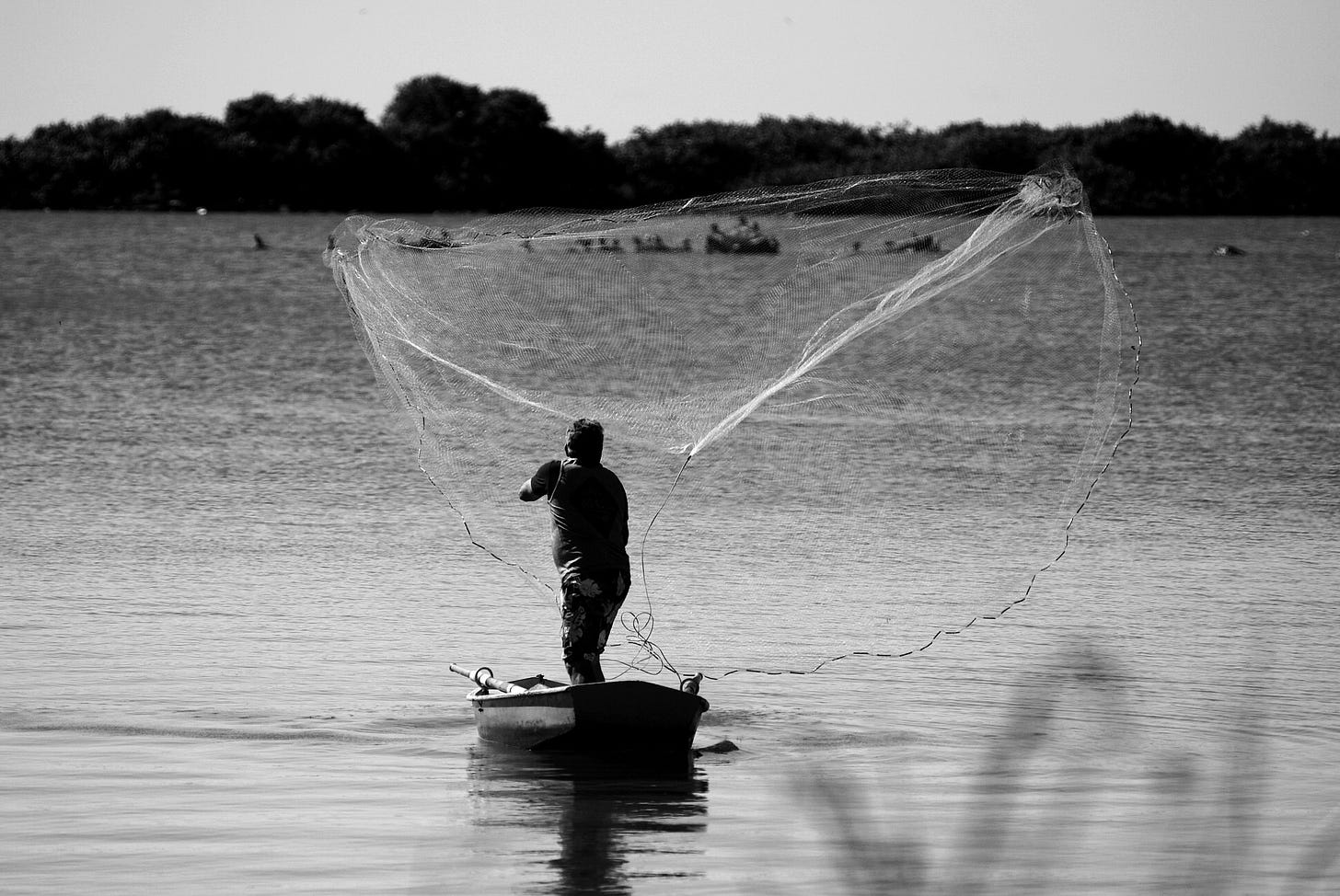 Fisherman casting out net