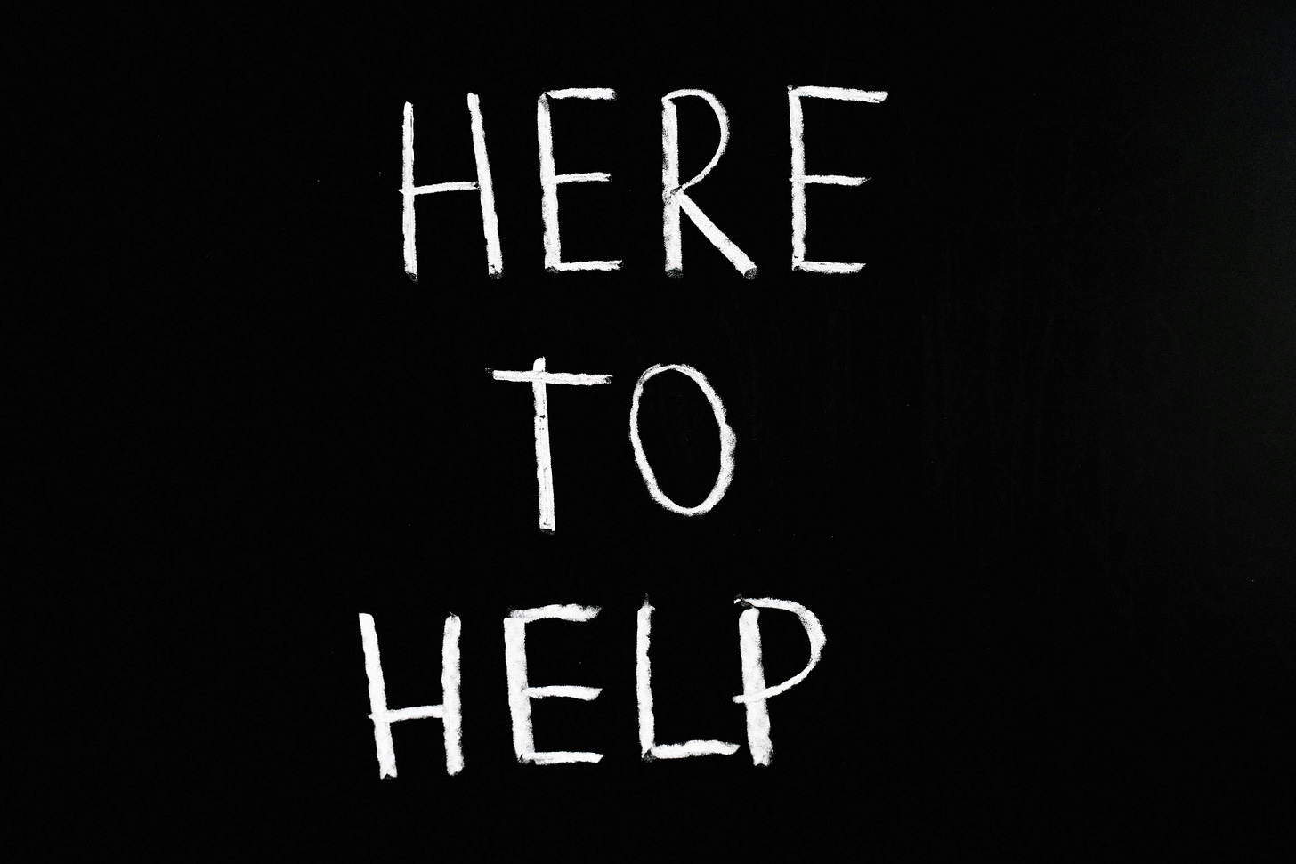 here to help lettering text on black background here to help lettering text on black background