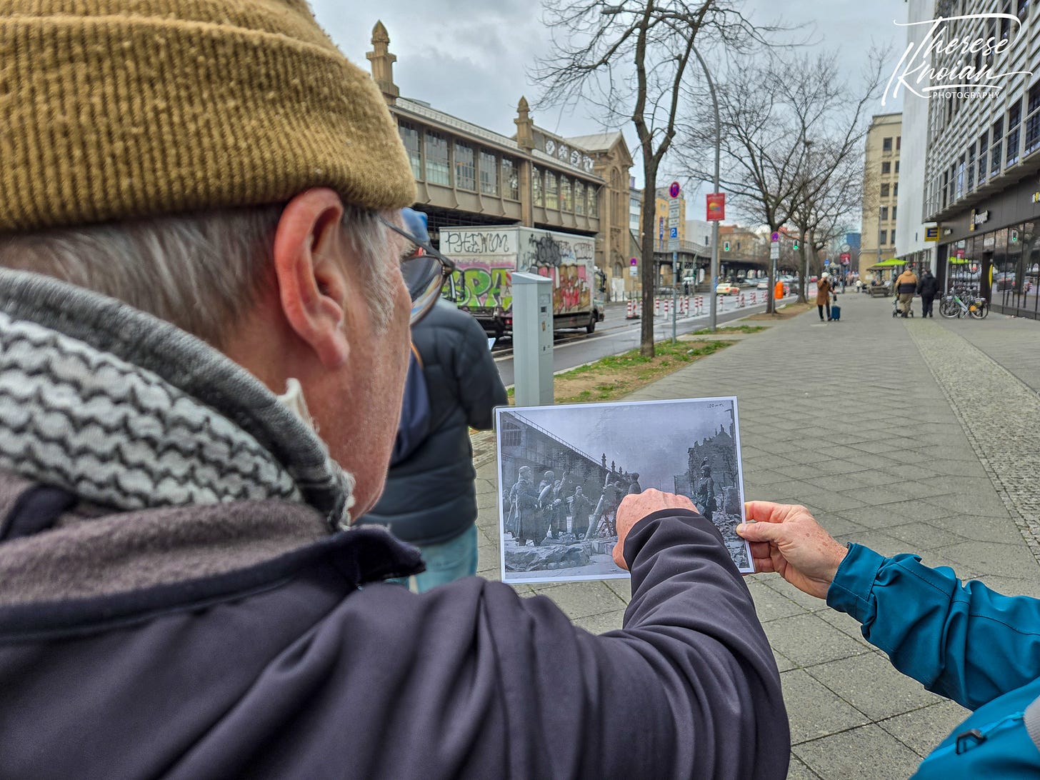 Peter Graham points at Soviet troops in an historic photo taken on Bulow Street in the Berlin Battle Damage tour.