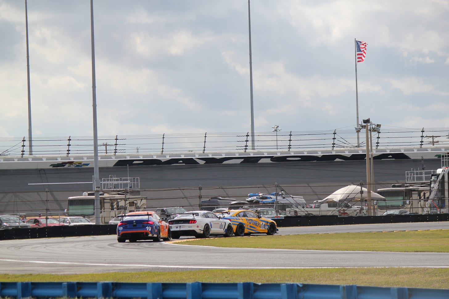 IMSA VP Challenge GSX class competitors Francis Selldorff, Jim Farley, and Sean Quinlan run nose to tail around a tight infield turn at Daytona International Speedway.