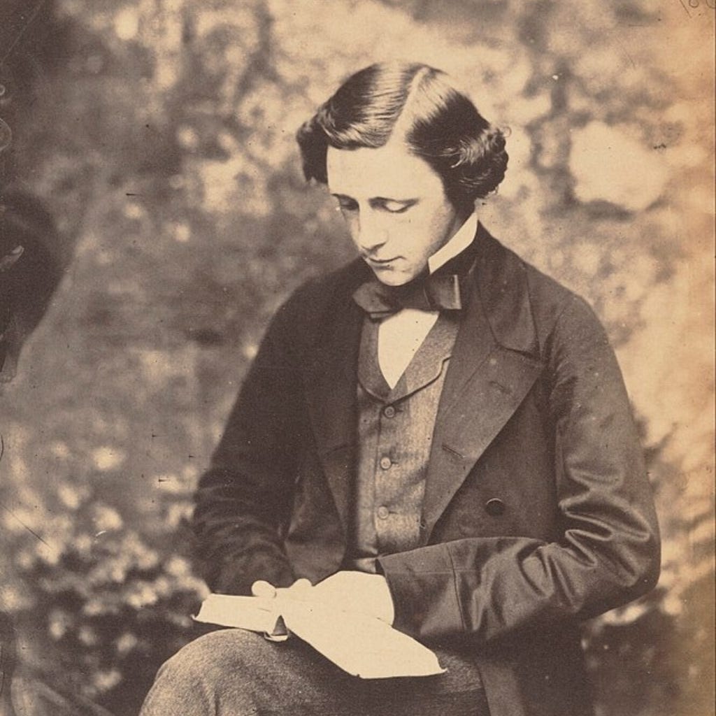 Picture of Lewis Carroll, author of Symbolic Logic and The Game of Logic, seated, reading a book.
