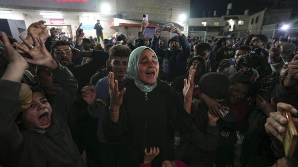 Palestinians celebrate the announcement of a ceasefire deal between Hamas and Israel in Deir al-Balah, central Gaza Strip, Wednesday, Jan. 15, 2025.