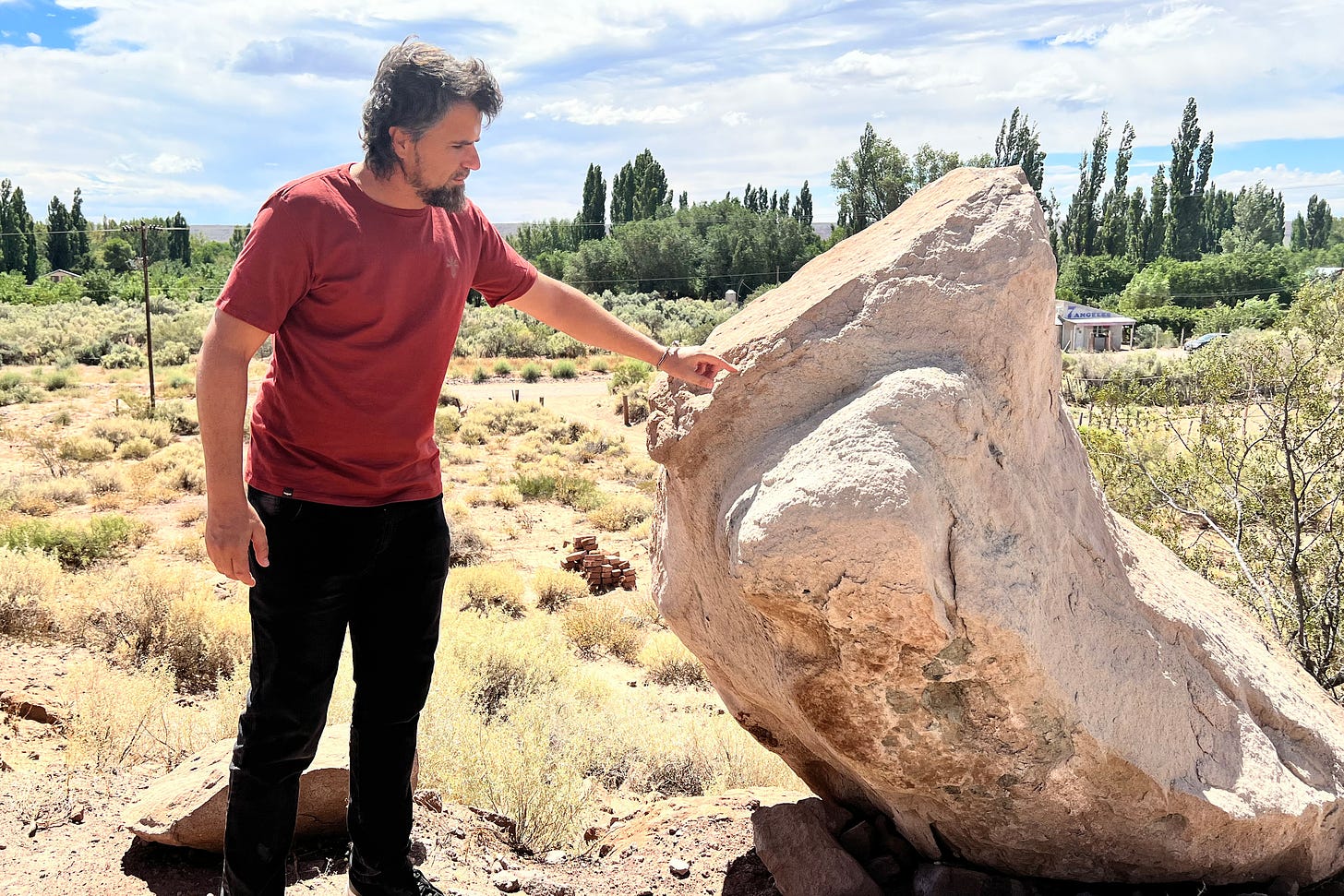 Javier Grosso points to a boulder that dislodged during one of the earthquakes that shook the town of Sauzal Bonito since fracking operations began nearby. Locals say they fear landslides could cause property damage if the seismic activity continues. Credit: Katie Surma/Inside Climate News