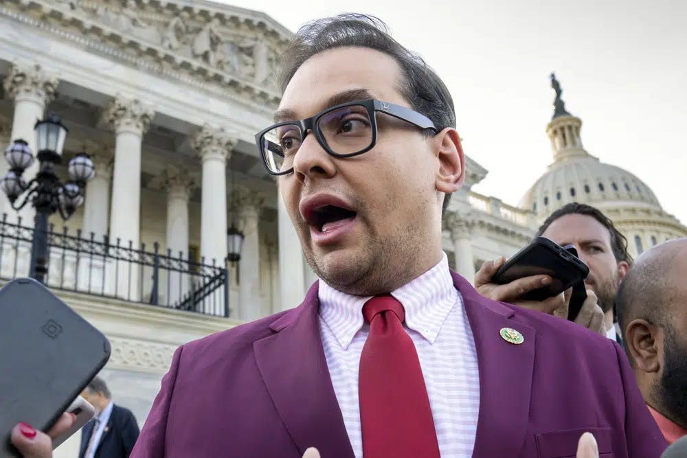FILE - Rep. George Santos, R-N.Y., speaks to reporters outside the Capitol, in Washington, May 17, 2023. Santos, 34, has spent weeks fighting efforts by news outlets to unseal the names of the two people who co-signed the $500,000 bond, which enabled his pretrial release as he awaits federal charges of fraud, money laundering and theft of public funds. (AP Photo/J. Scott Applewhite, File)