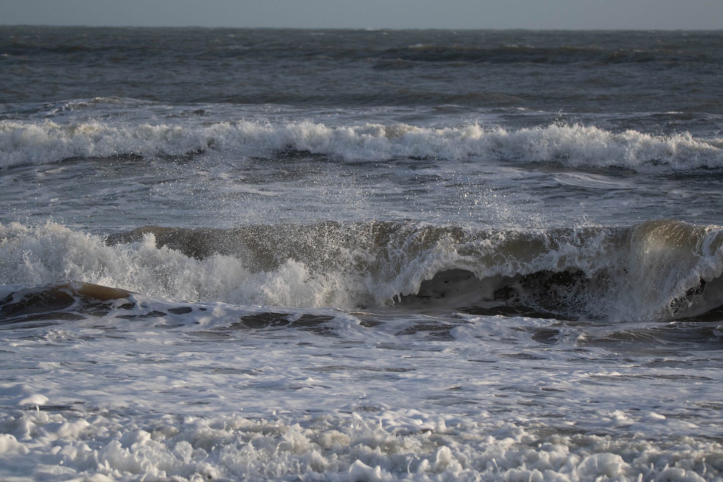 Waves breaking against the beach. 