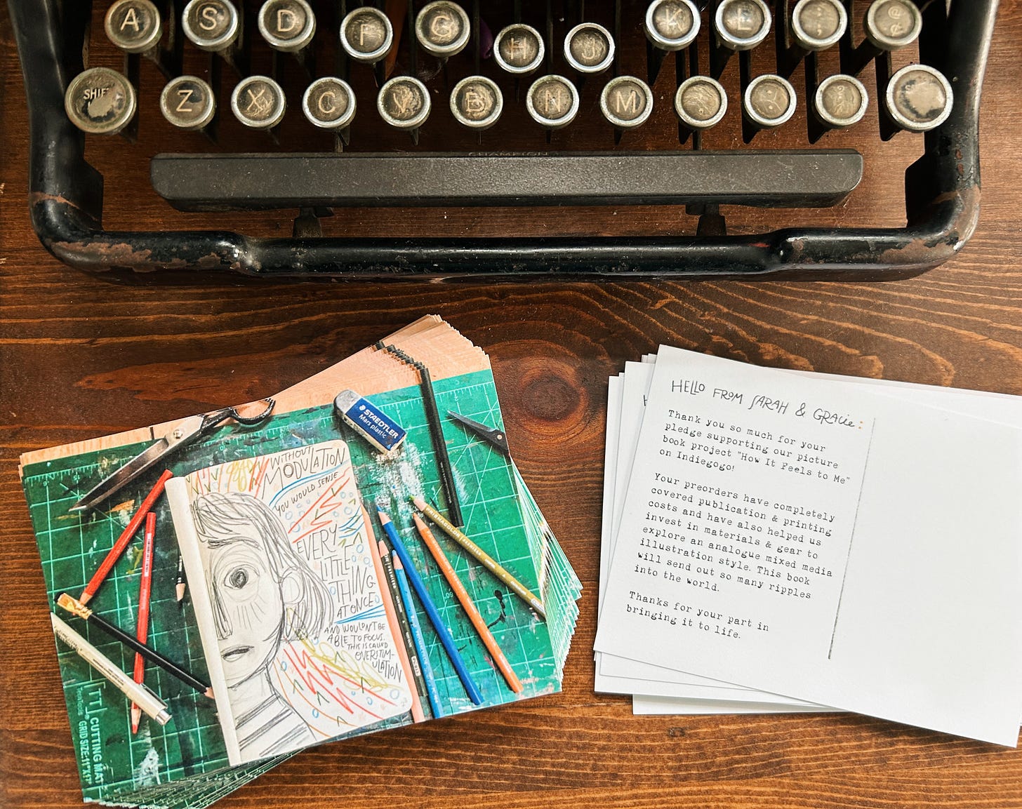 Stack of thank you postcards beside Sarah's vintage Underwood typewriter