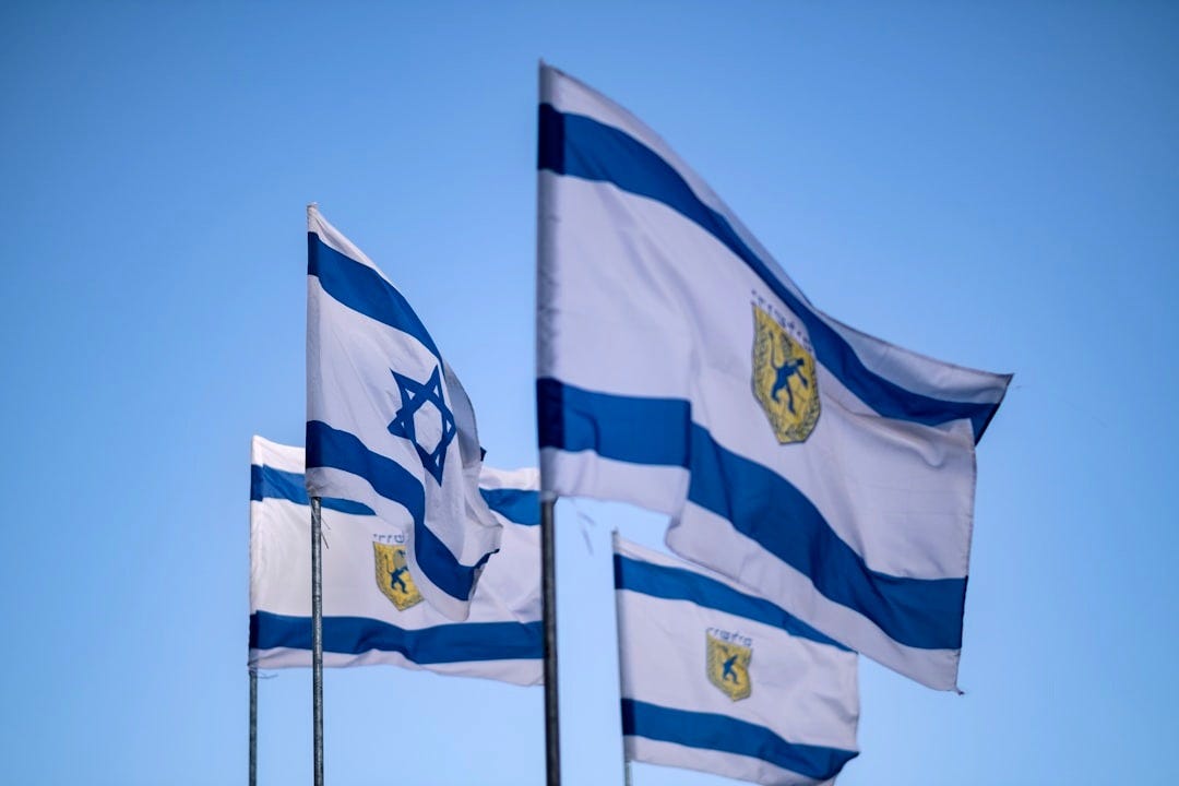 blue and white flags on white metal poles