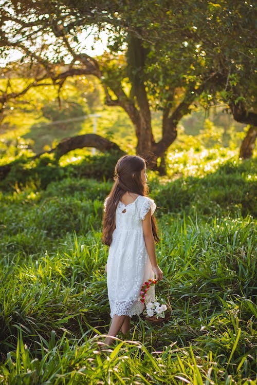 Free Girl in White Dress Walking on Meadow Stock Photo