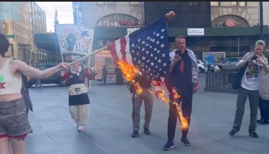 A person holding a flag on fire

Description automatically generated