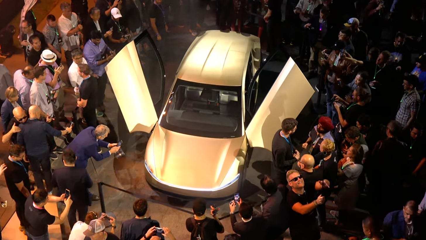 Tesla fans surrounding a Cybercab prototype