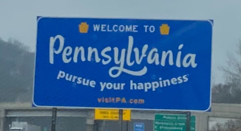 A welcome sign to Pennsylvania, proclaiming welcome to pennsylvania, pursue your happiness