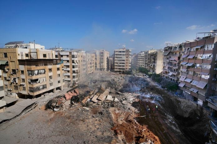 People gather at the site of the assassination of Hezbollah's leader Hassan Nasrallah in Beirut's southern suburbs on Sunday, September 29, 2024.