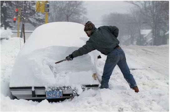A resident of Minneapolis digging a car out of the snow after the Halloween Blizzard, 1991. Photograph by Rita Reed, Minneapolis Star Tribune.