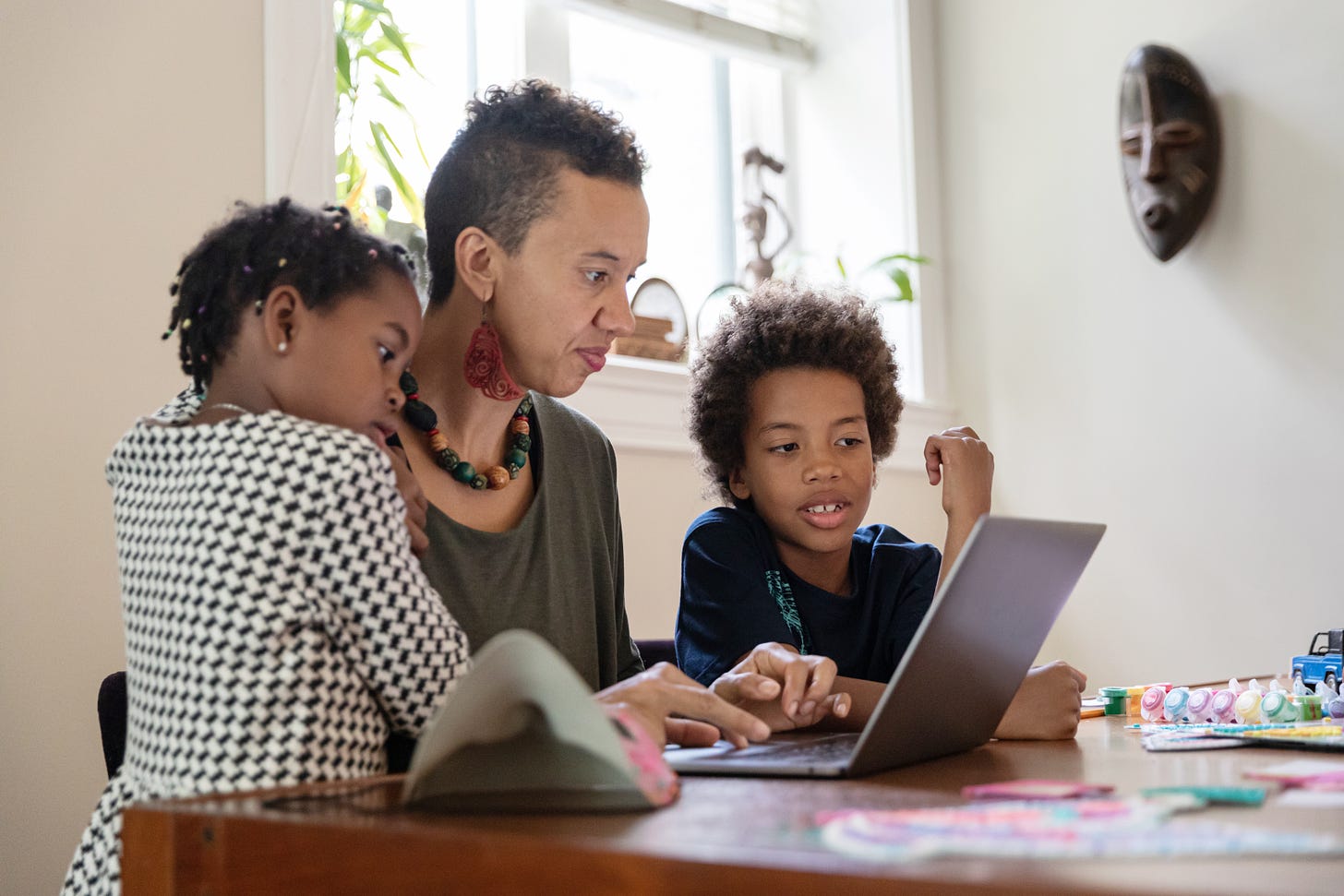 Woman on laptop with children