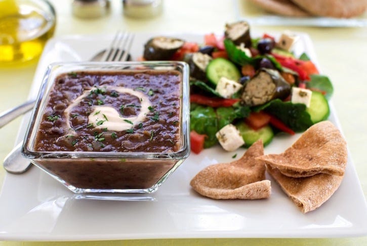 Quick black bean soup served with Greek salad