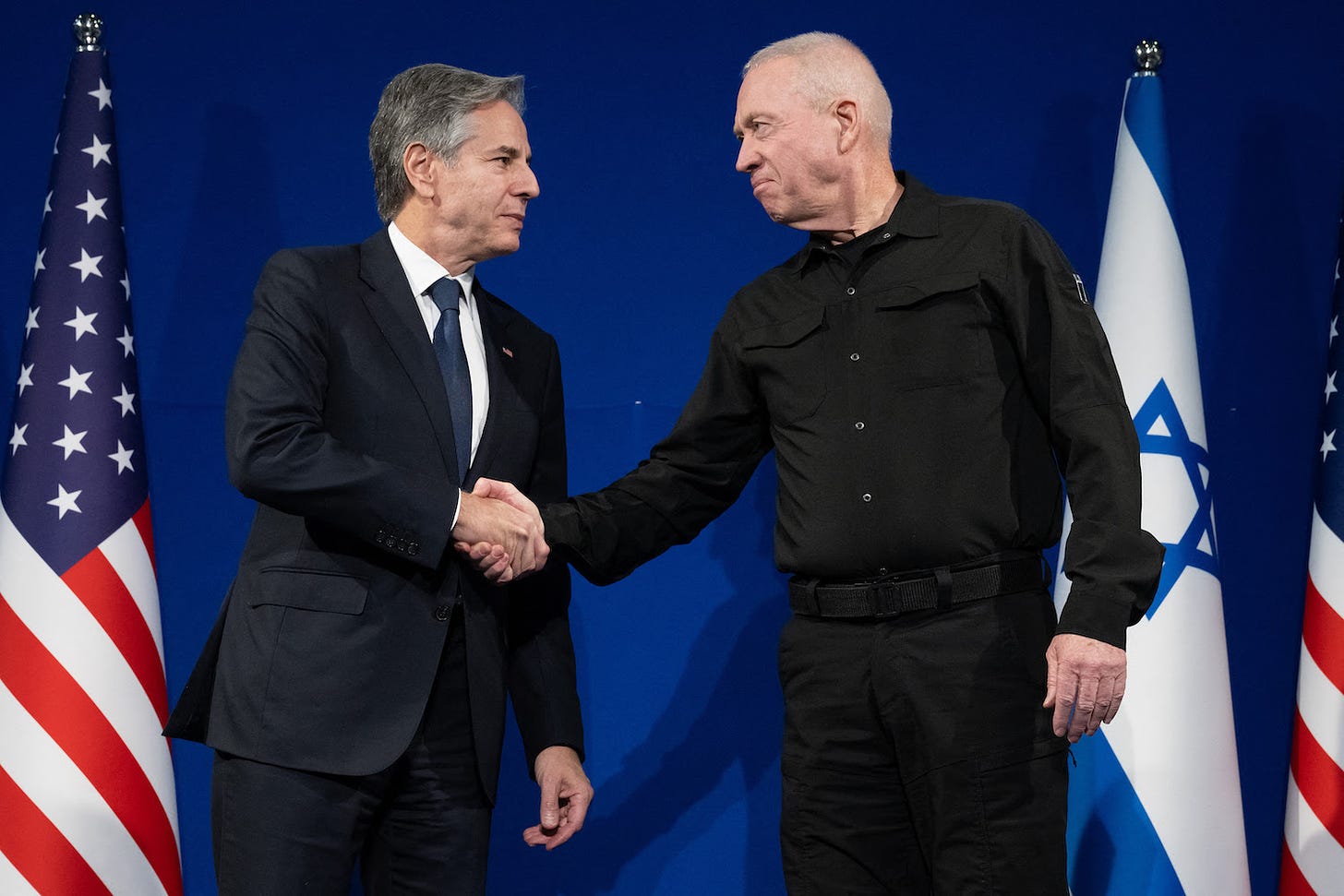 Israeli Defense Minister Yoav Gallant and U.S. Secretary of State Antony Blinken shake hands.