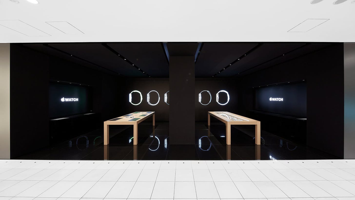 Apple Watch at Isetan Shinjuku, photographed straight-on. The interior of the store is totally black.