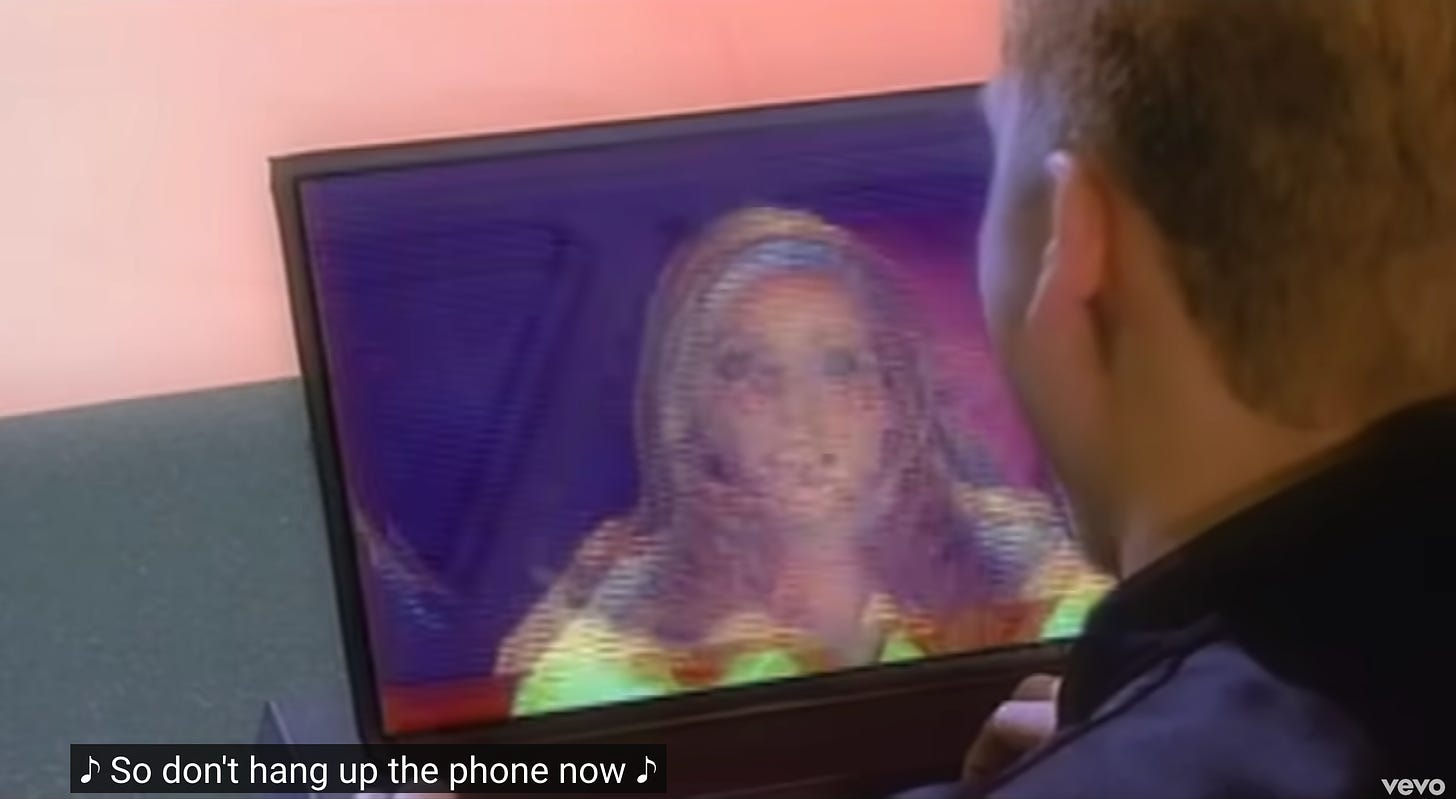 Looking over Lance's shoulder at a laptop screen, there's a girl in a yellow shirt with a headband that looks a lot like Sarah Michelle Gellar