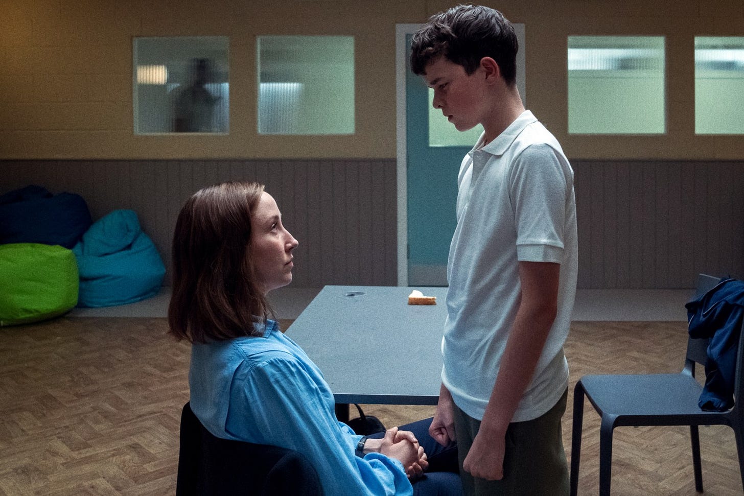 Adolescence': Netflix Miniseries Jamie Miller looms over his seated therapist, Briony Ariston, during a confrontational moment in Adolescence, capturing the imbalance of power.