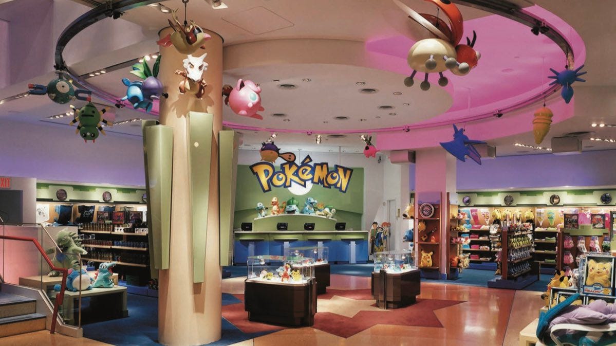 Photograph of the ground floor of the Pokémon Center New York, filled with animatronics and various Pokémon products.