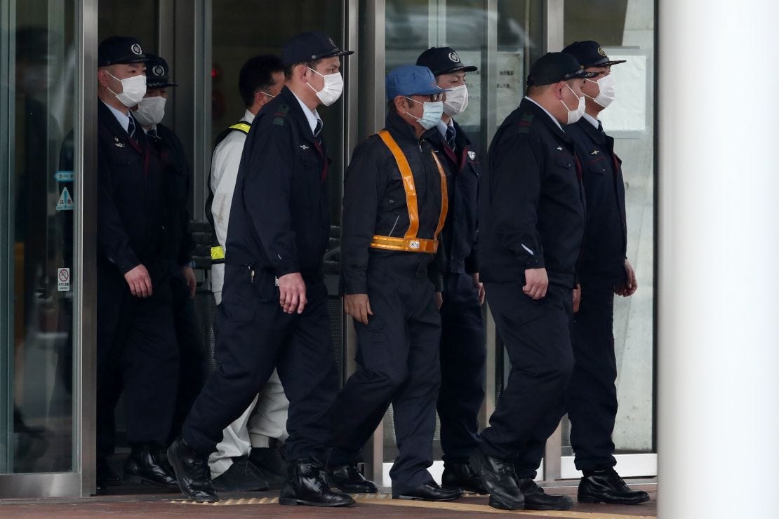 Former Nissan chairman Carlos Ghosn, wearing a  blue cap and a face mask, when he was released on bail.