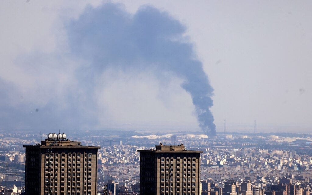 Smoke billows in the distance from an oil refinery following an Israeli strike on the Iranian capital Tehran on June 17, 2025. (ATTA KENARE / AFP)
