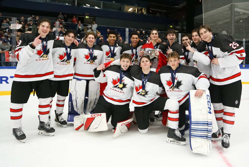 Players from the Canada U18 team pose together to celebrate winning the gold medal.